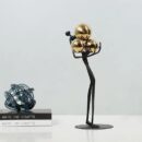 FIGURE HOLDING BALLS DECOR