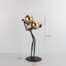 FIGURE HOLDING BALLS DECOR